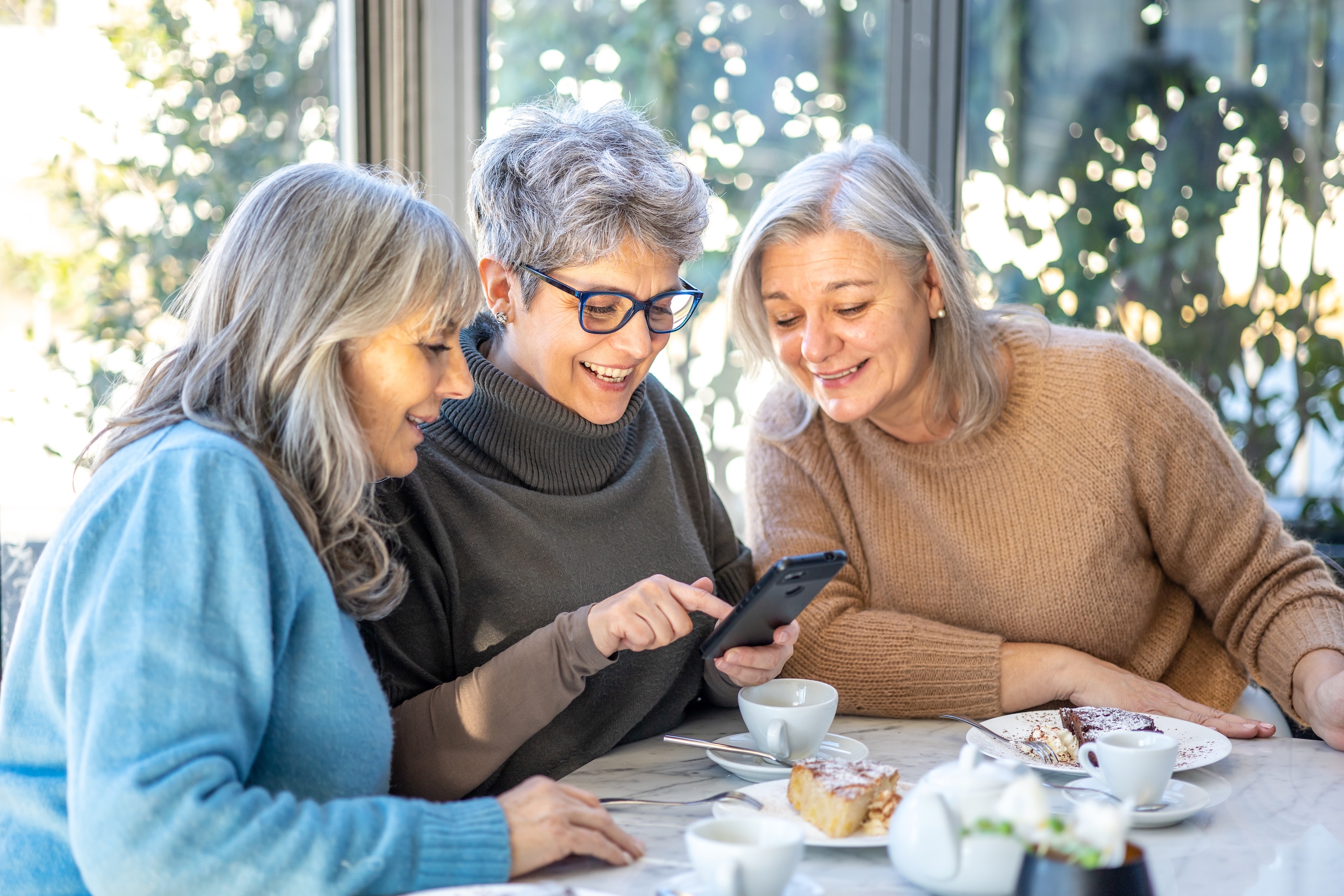 Senior woman looking at phone stock photo