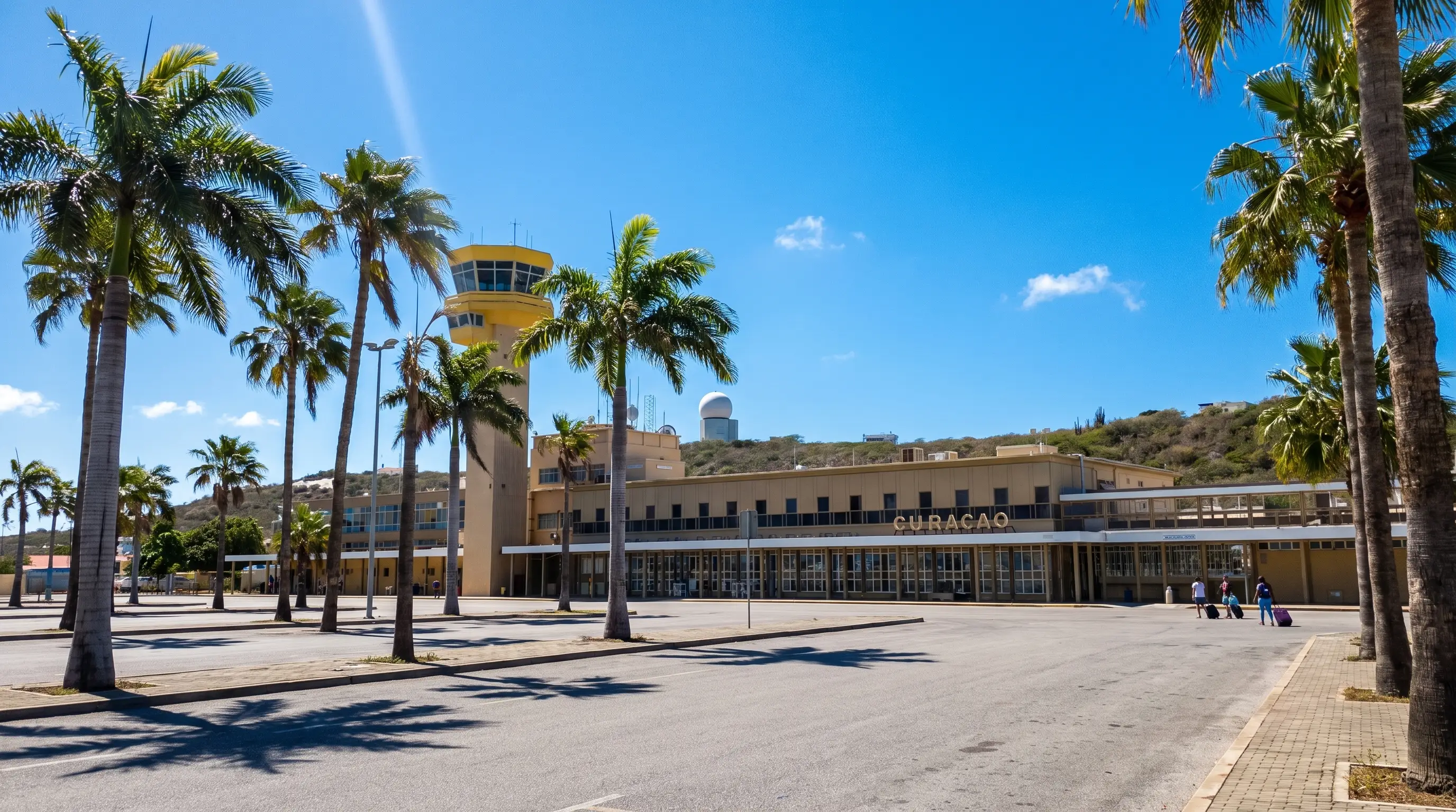 Airport terminal with a control tower and palm trees in Curaçao