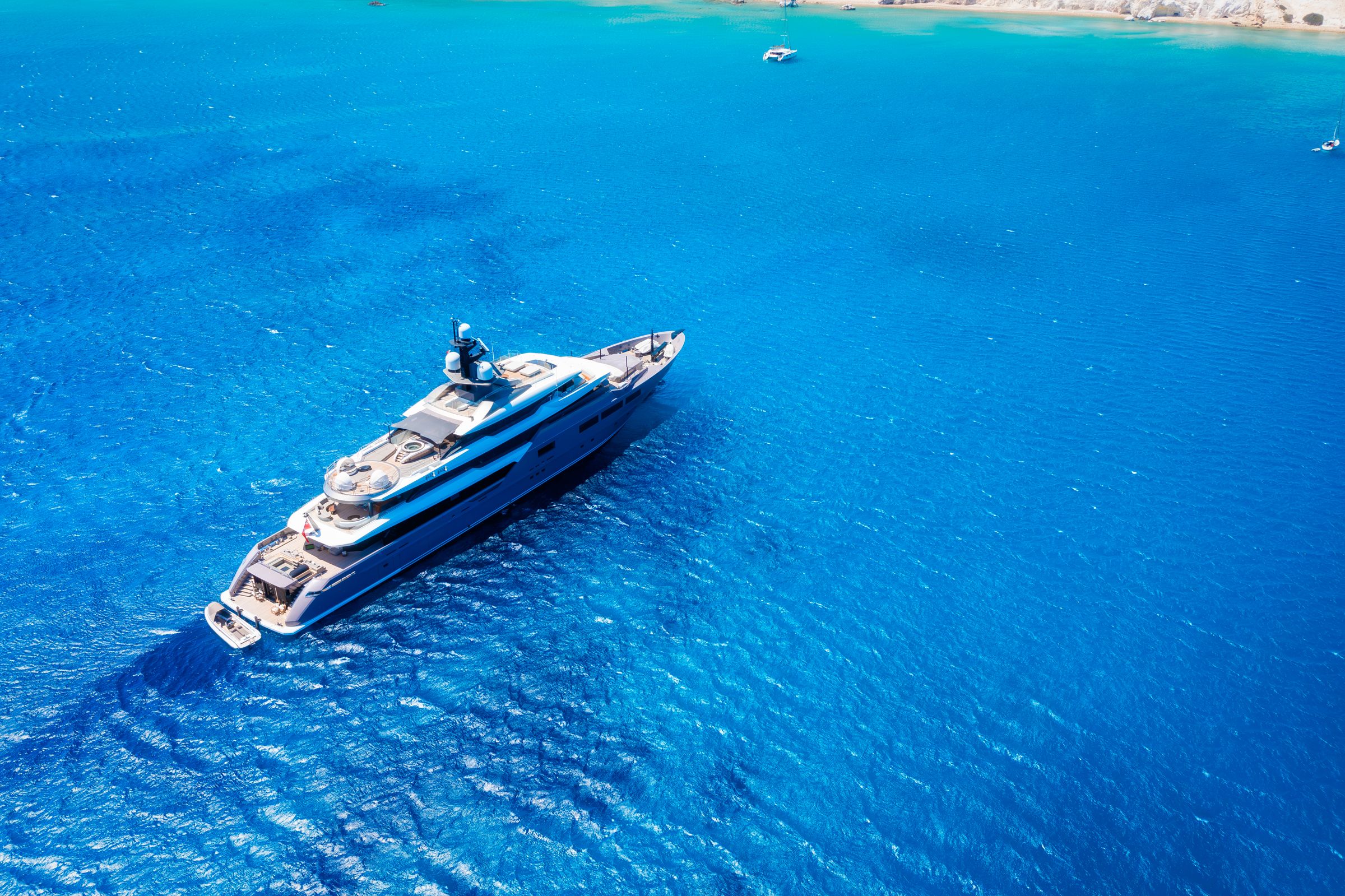 Superyacht cruising through deep blue water
