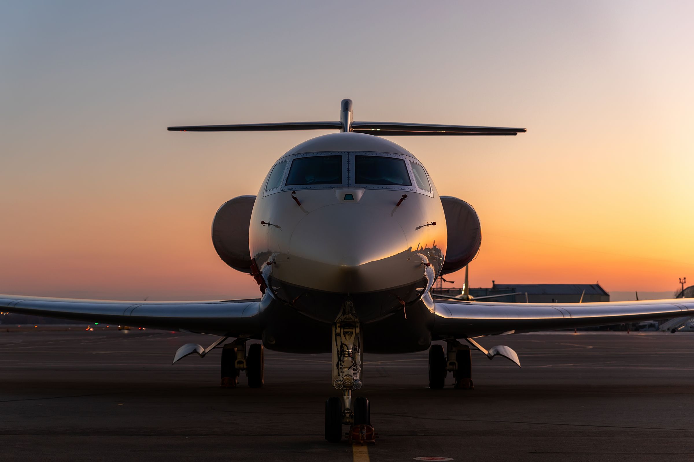 Private jet on the runway at sunset