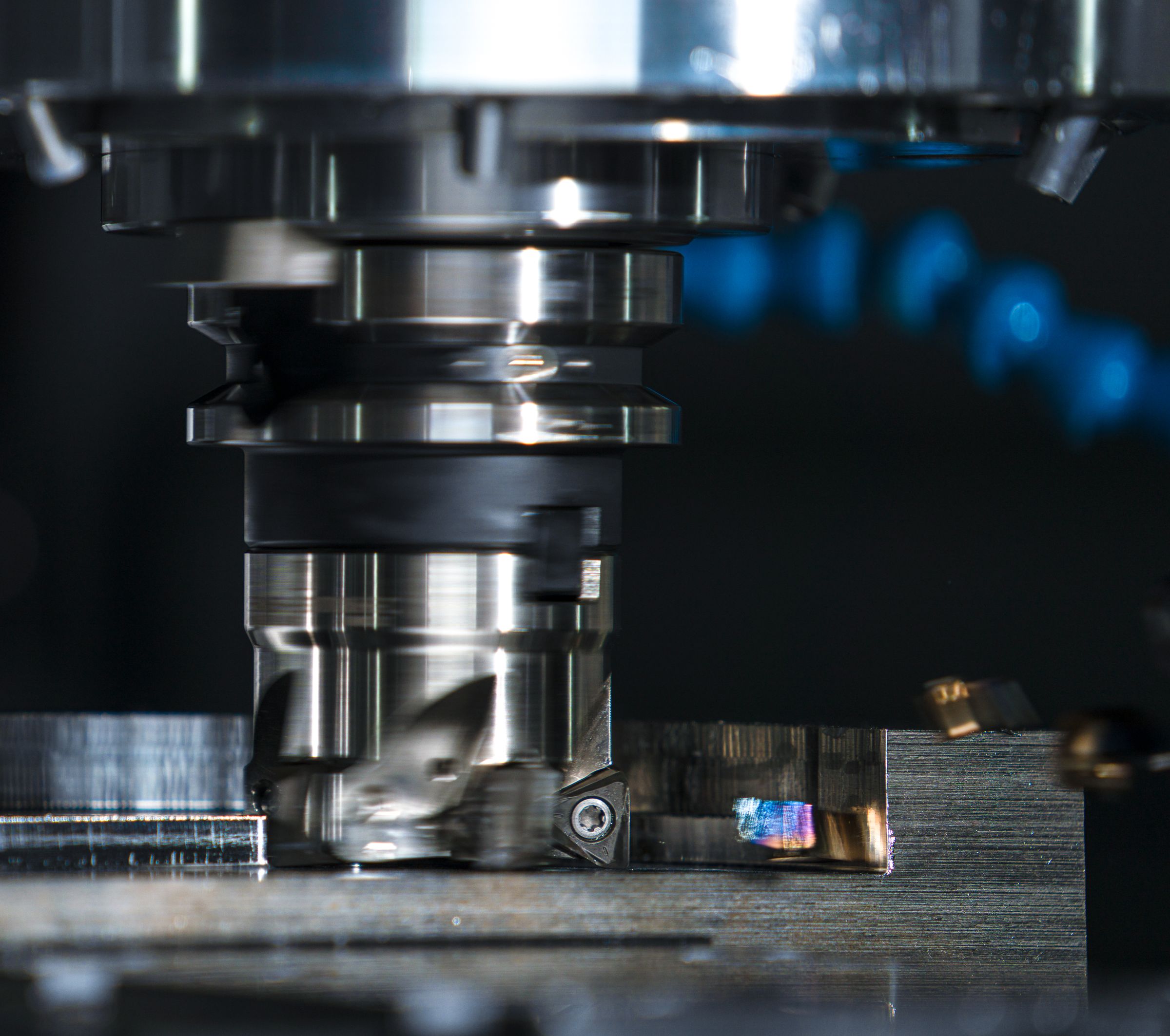 Close-up of a CNC milling cutter machining a steel part