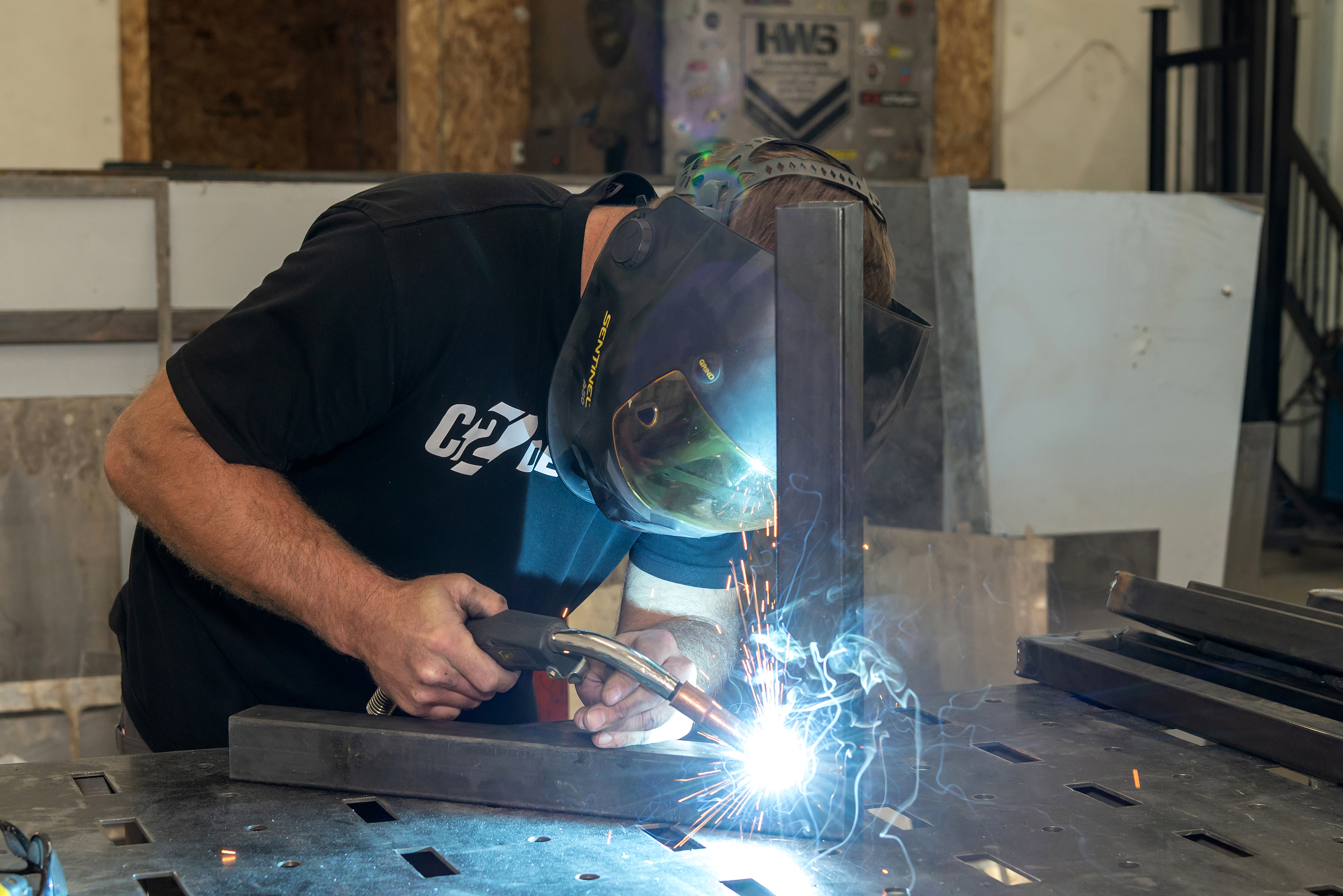Welding a custom steel frame in the C2 Designs workshop