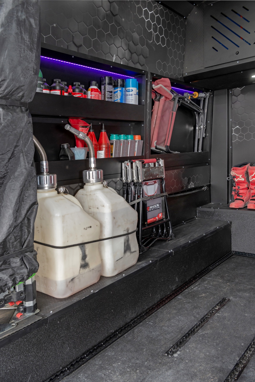 Custom van shelves holding tools, fluids and riding gear