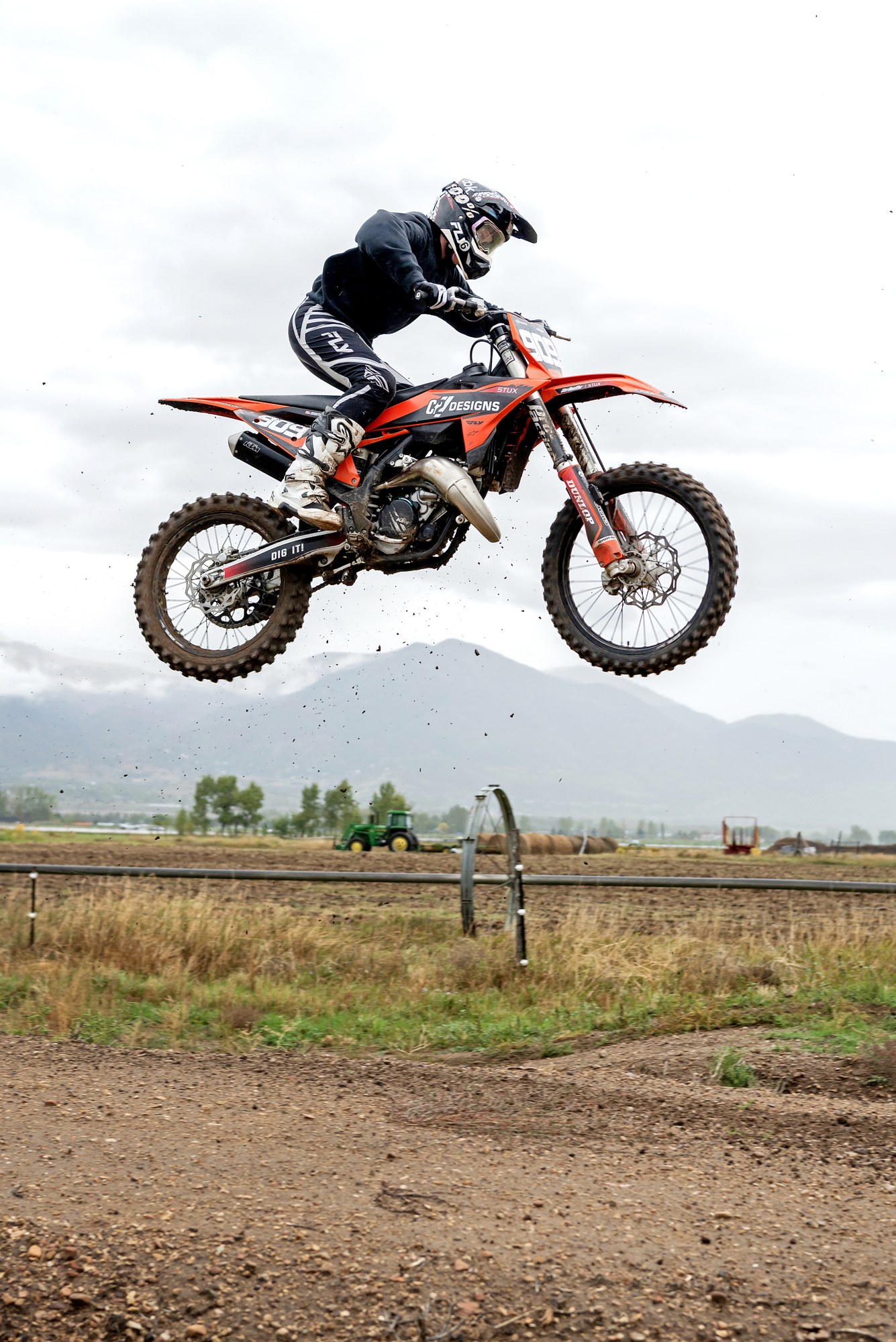 Rider jumping an orange C2 Designs dirt bike