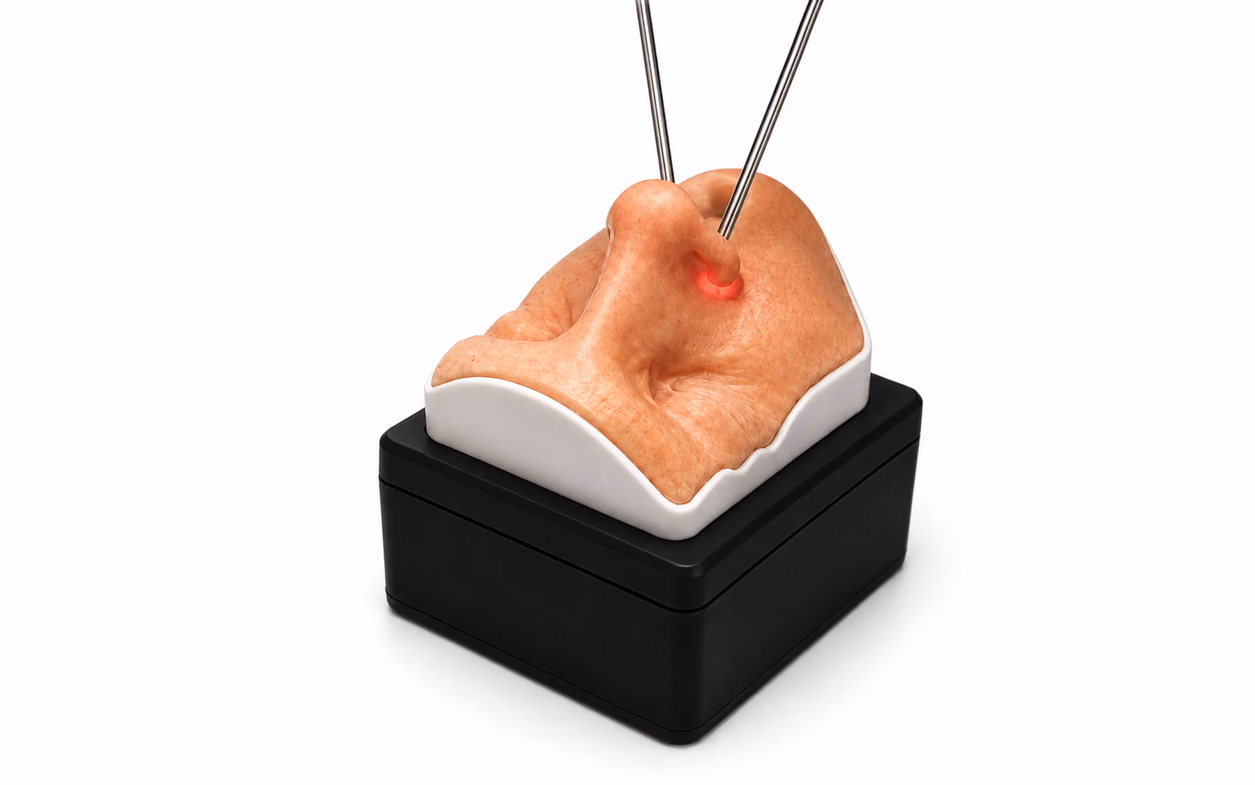 Medical training model of a human nose mounted on a black base, with two metal probes inserted near the nostrils and a red light glowing at the insertion point.