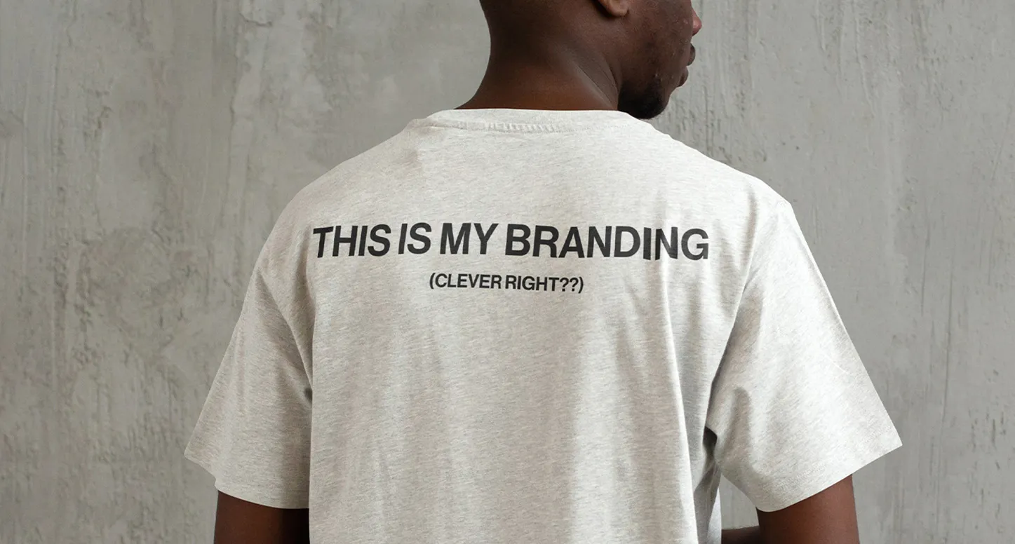 A man wearing a graphic tee that says, "this is my branding (clever right??)" for POLA Marketing Agency's Digital Marketing guide