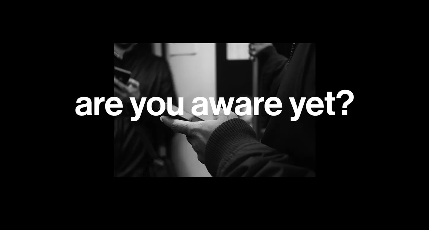 A hand holding a phone with "are you aware yet?" layered on top for POLA Marketing's social media marketing guide for e-commerce