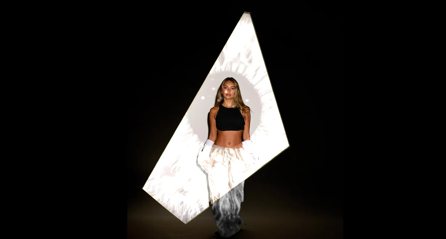 A photo of a blonde model walking toward the viewer in a white boxy spotlight for POLA Marketing's guide to building an e-commerce branding strategy