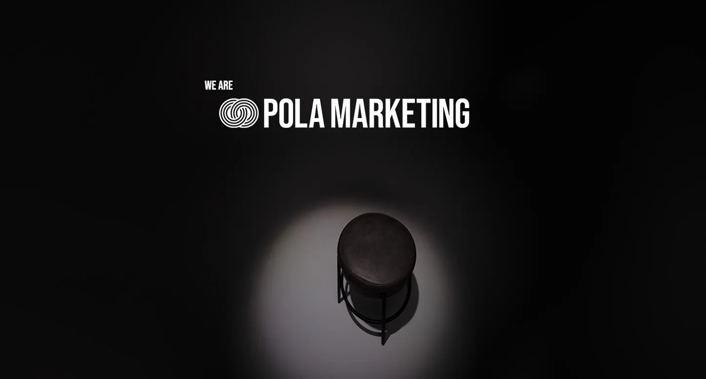 A black stool in the spotlight with the phrase "We are POLA marketing" above it