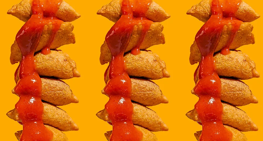Red sauce pouring over fried dumplings for POLA Marketing Agency's Amazon product photography guide.