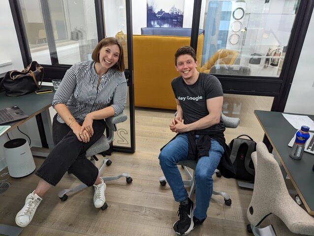 Two team members at their desks