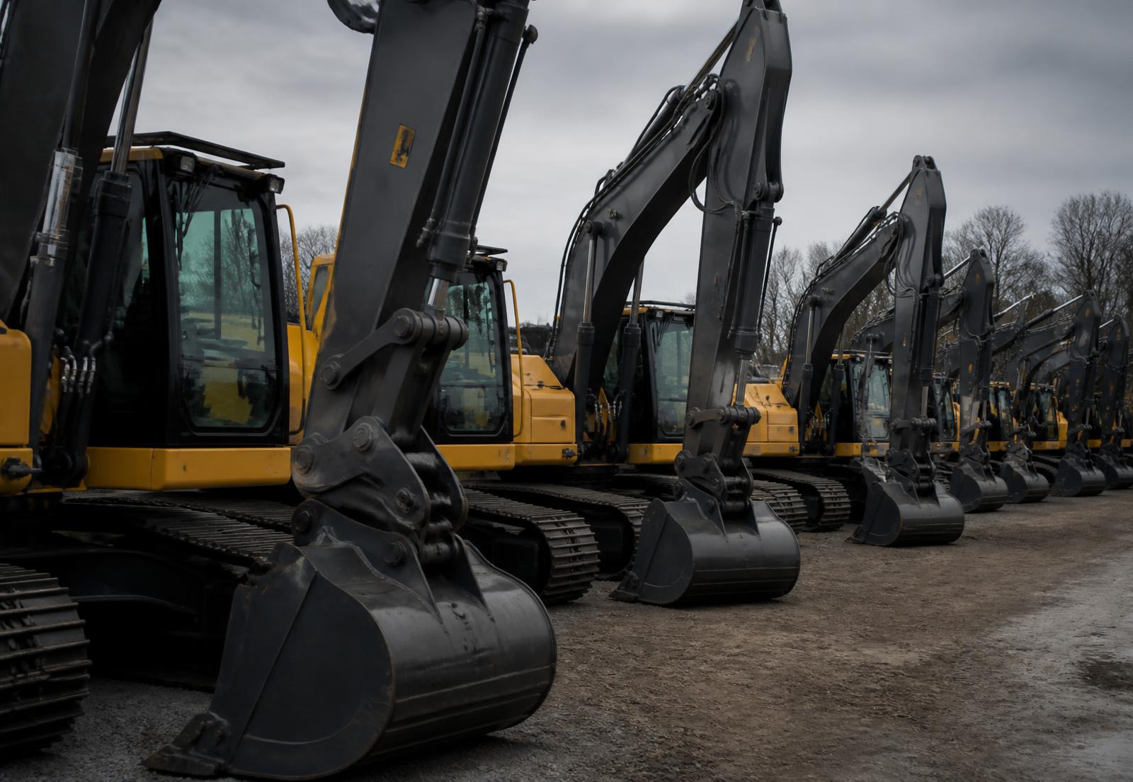 Heavy equipment lined up at a contractor yard
