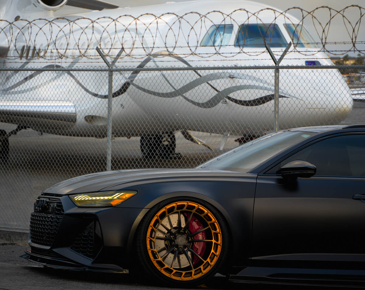 Matte black Audi RS6 Avant front three-quarter view