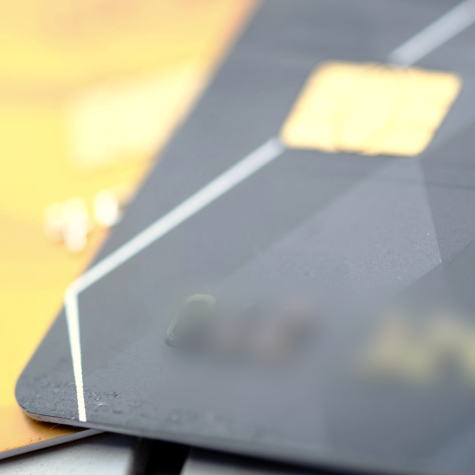 Close-up of a dark payment card with a gold chip