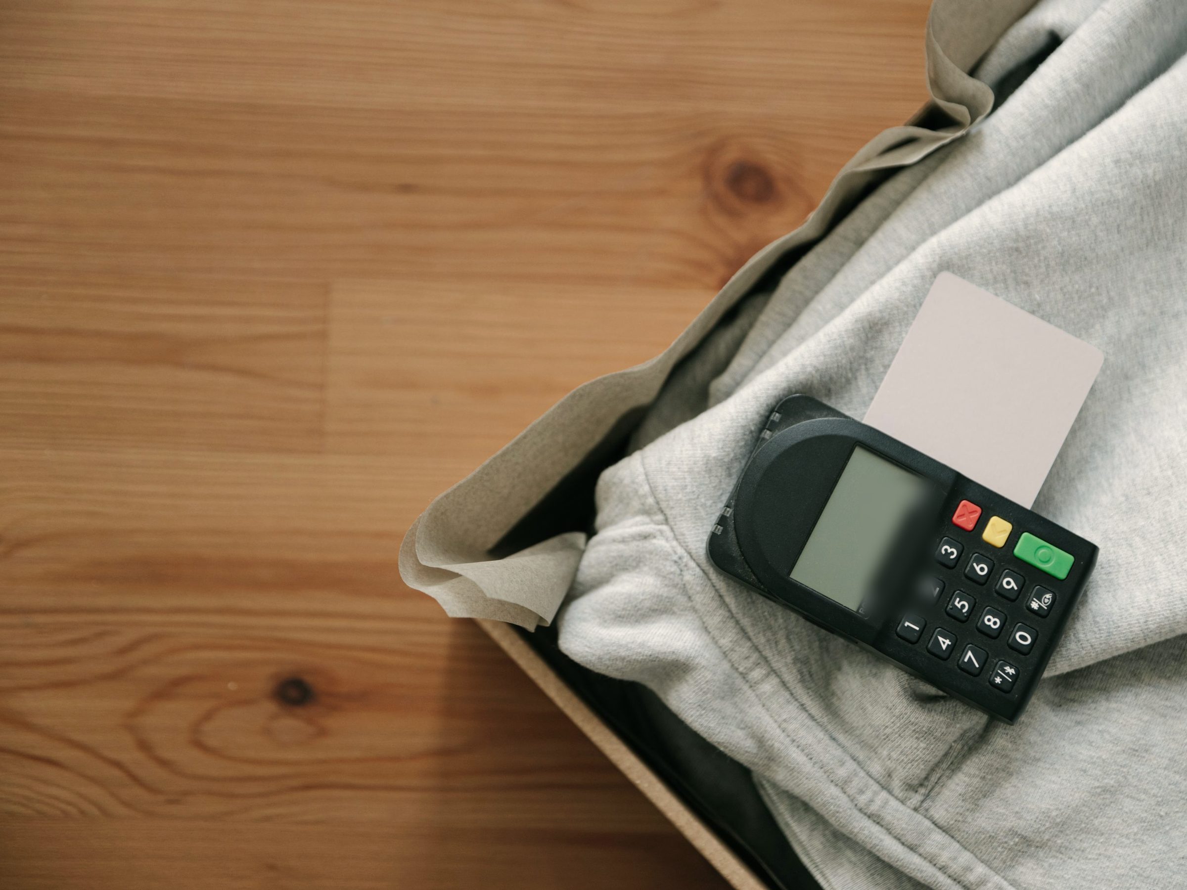 Card payment terminal and card on a folded grey hoodie