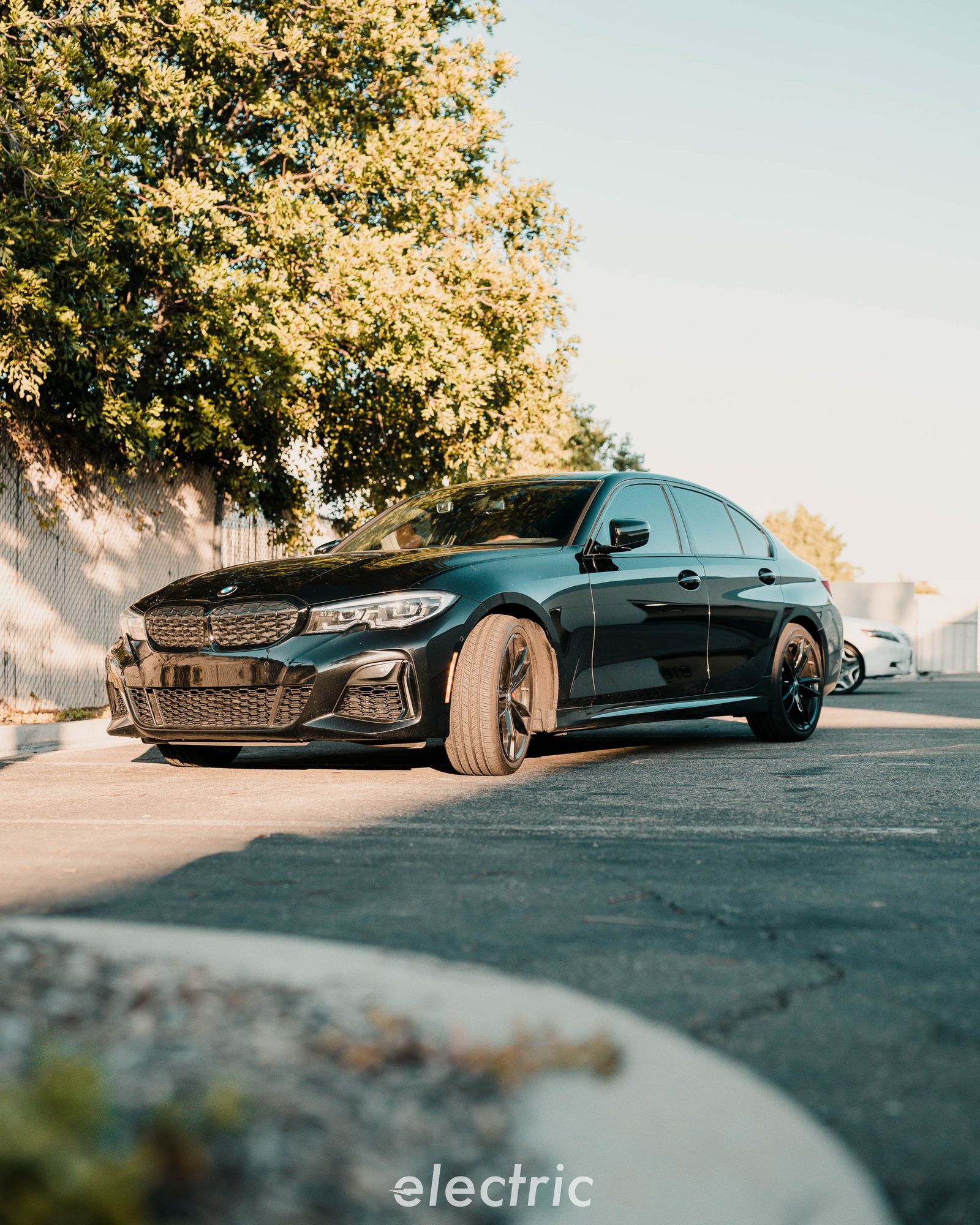 Dark BMW 3 Series sedan parked outside the shop