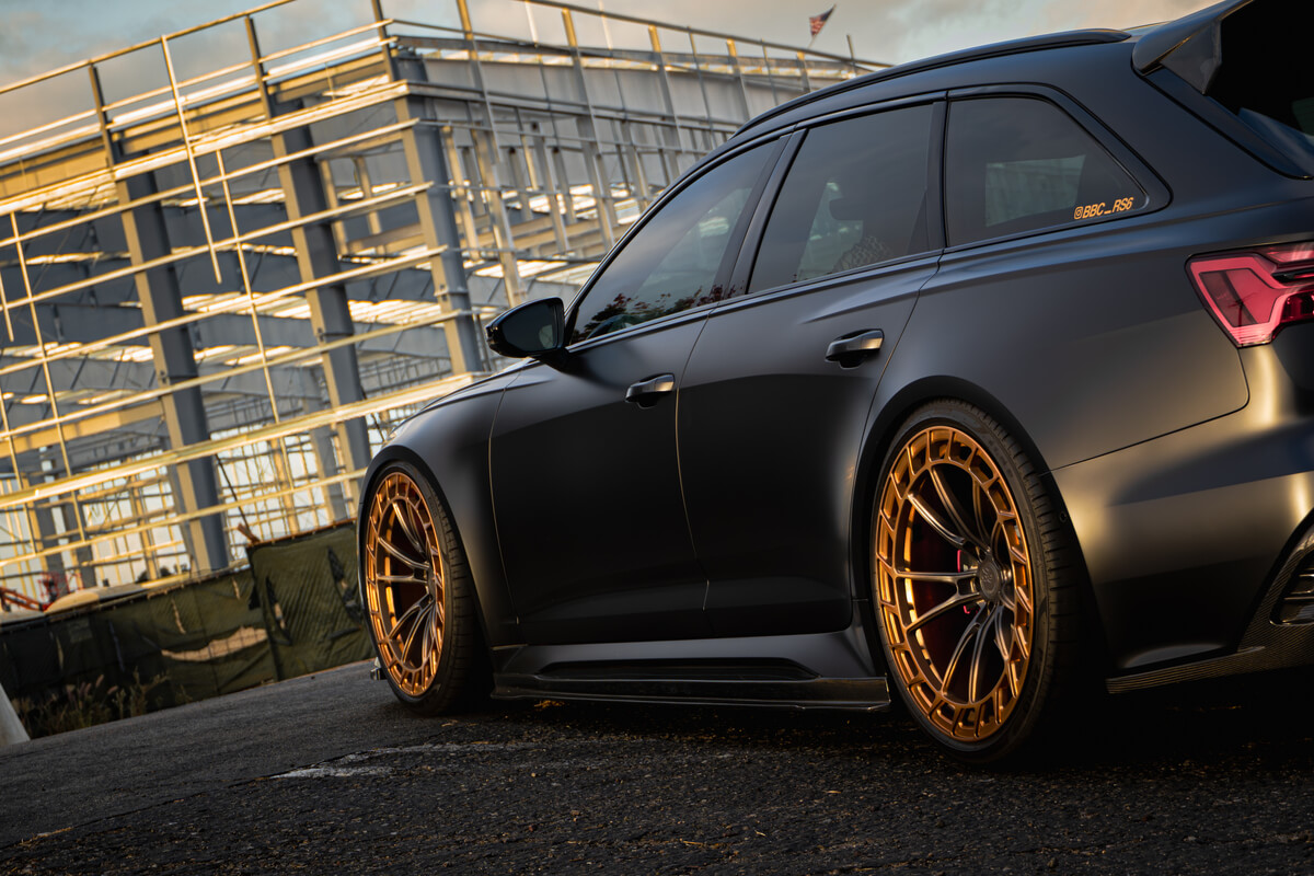 Matte black Audi RS6 Avant rear three-quarter view