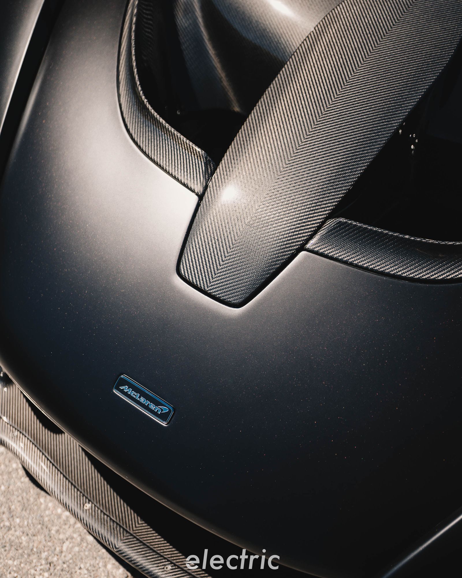 Exposed carbon fiber on the hood of a McLaren Senna