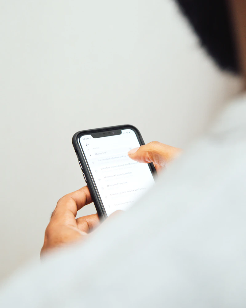 Person in a white top checking a care plan on their phone