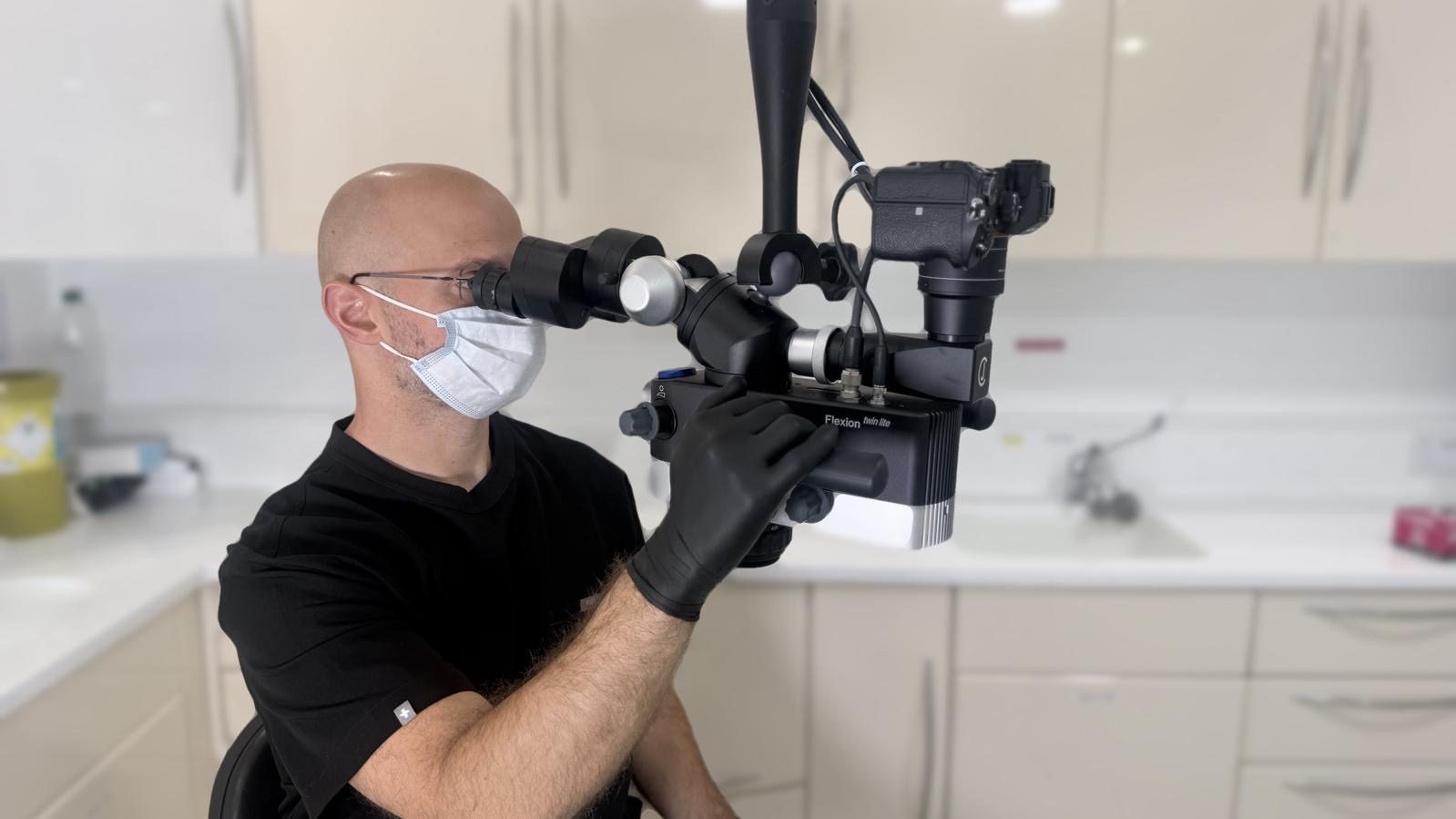 Dr Spencer Richman working under a dental operating microscope