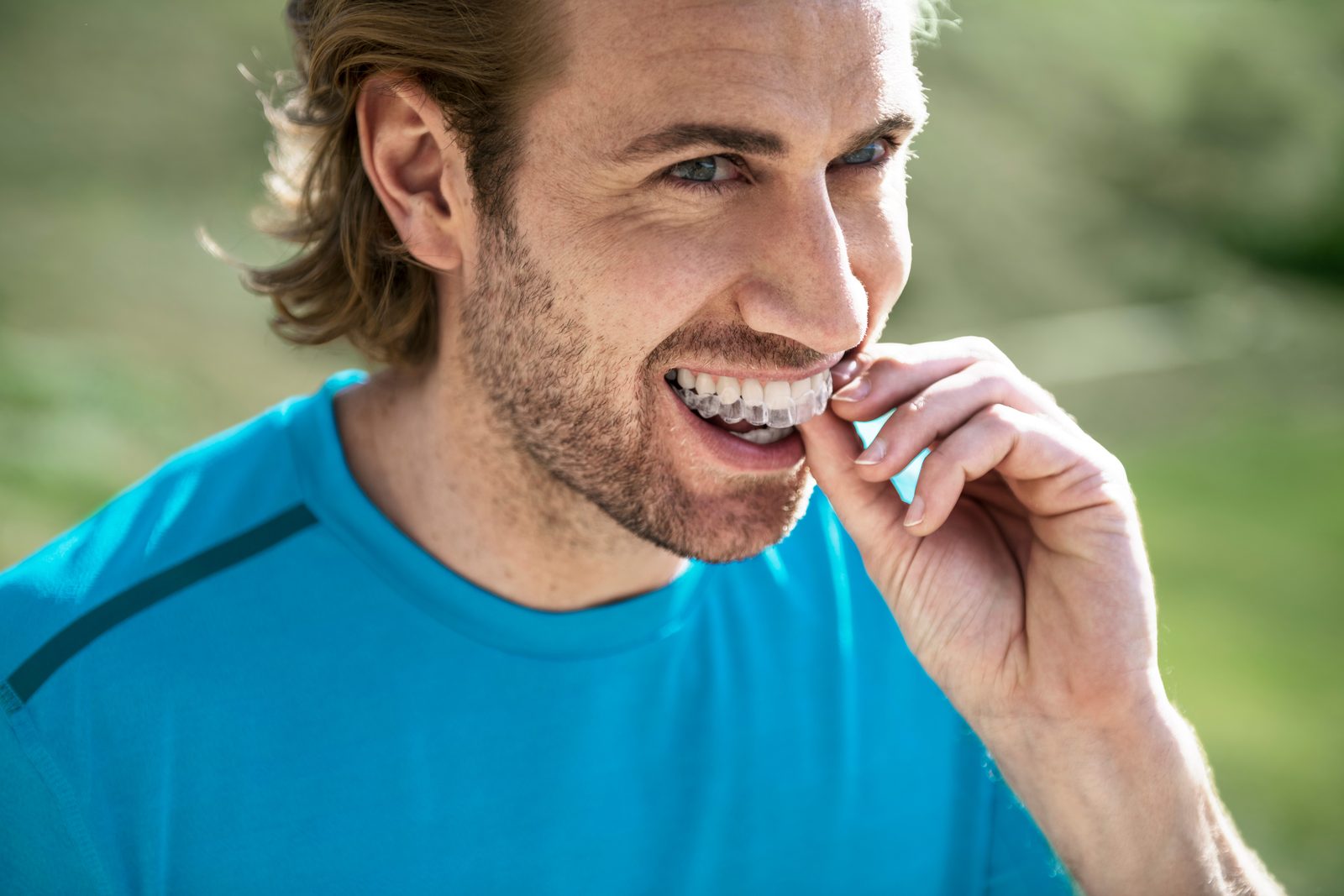 A man clicking an Invisalign aligner into place