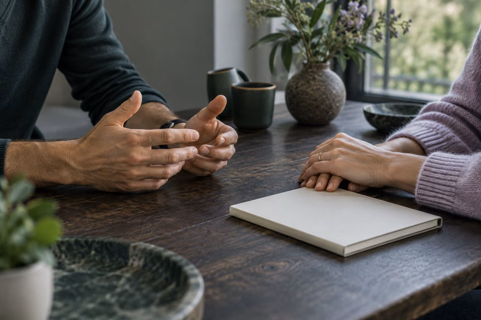 Two people talking across a table