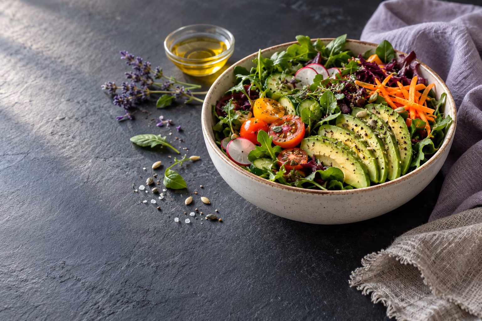 A bowl of colorful vegetables on a slate table