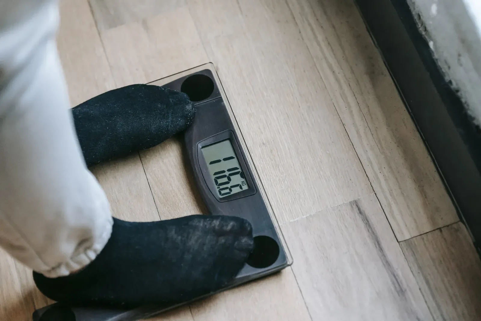 Feet resting on a digital bathroom scale.