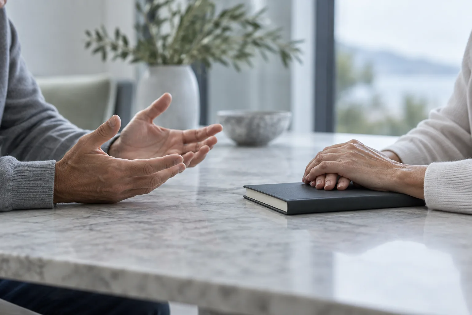 Illustration: Two adults’ hands in conversation beside a closed charcoal notebook.