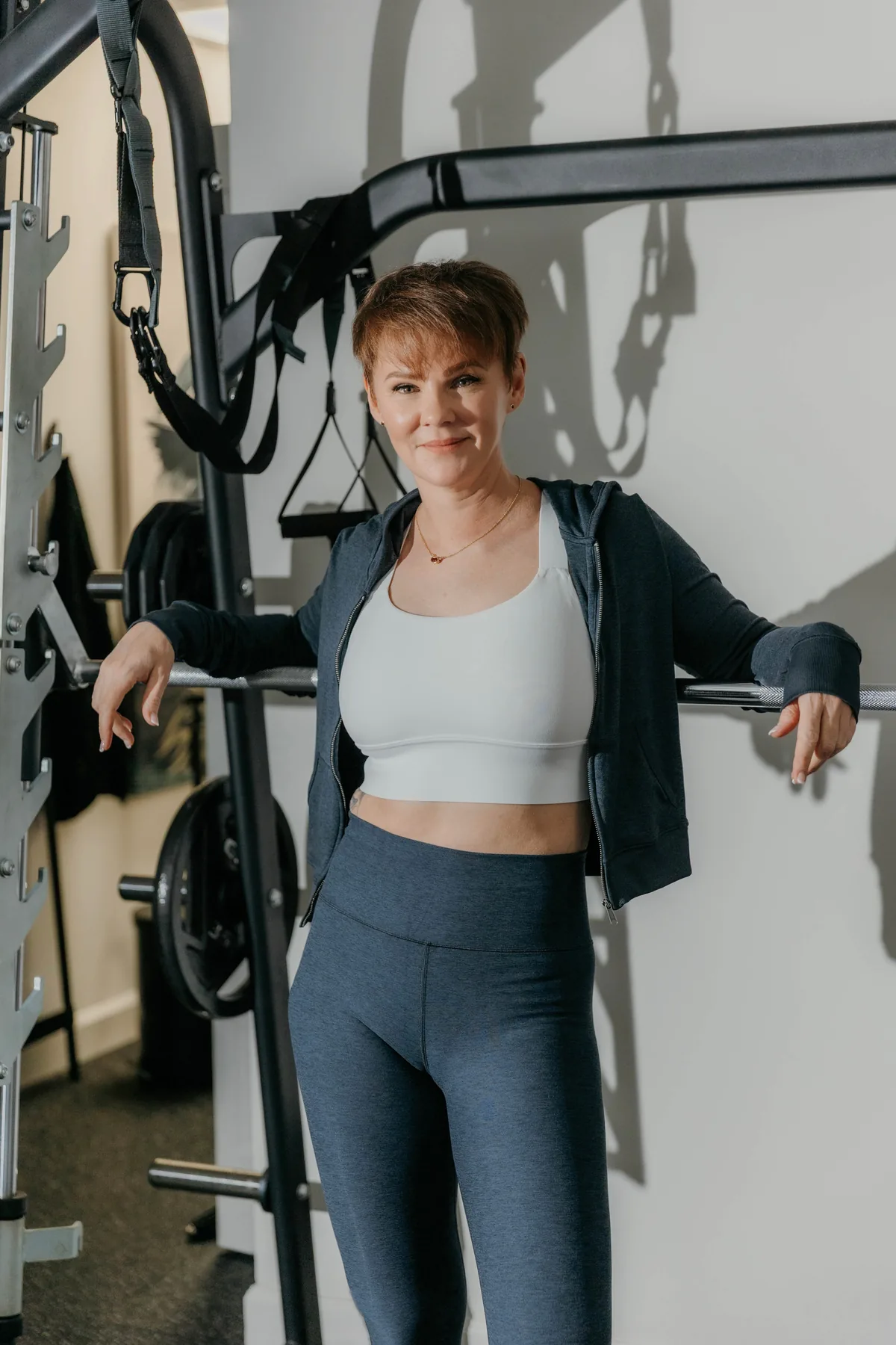 Kate Bolia beside strength-training equipment at Apex Dunwoody.
