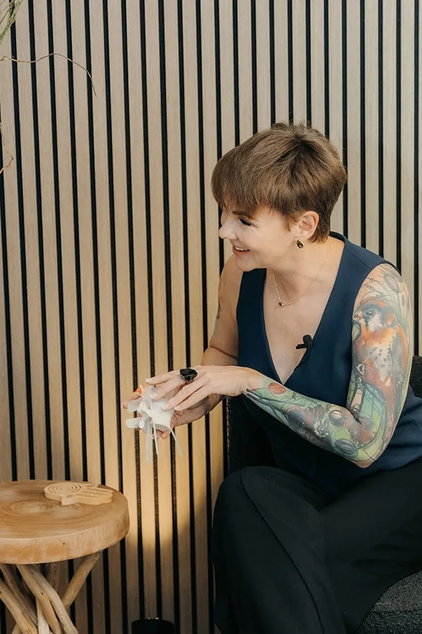 Kate Bolia explaining movement with an anatomical spine model.