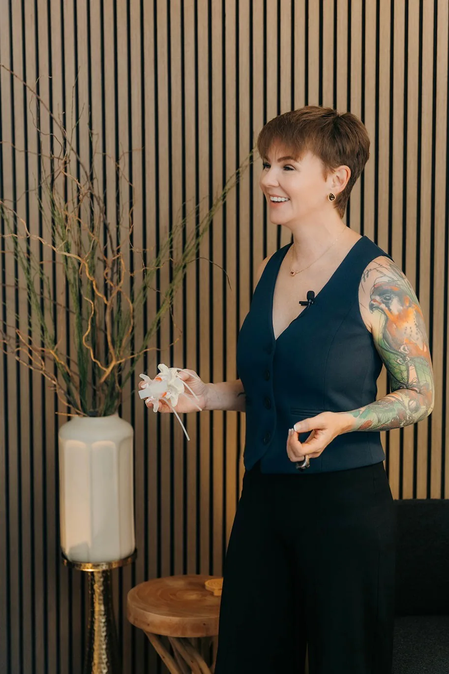 Kate Bolia holding an anatomical model while discussing movement at Apex Dunwoody.