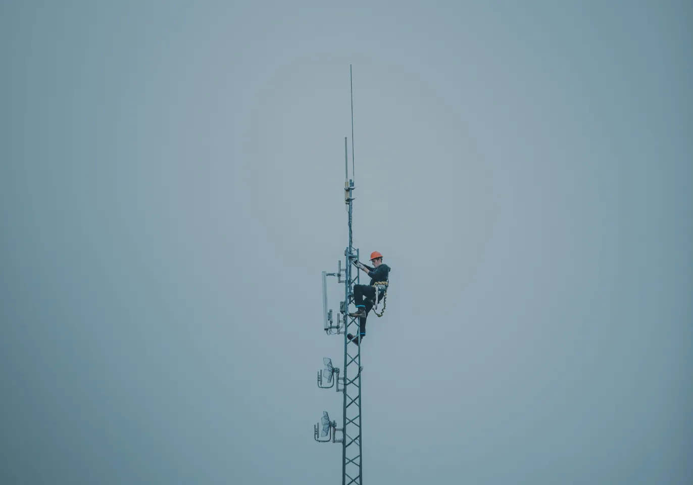 Technician climbing a telecom tower