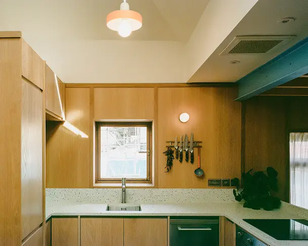 Timber-lined kitchen with a window above the sink