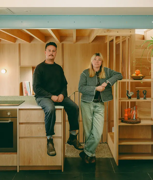 Alex Cox and Nina Jones, founders of Cox + Jones, in a timber-lined kitchen