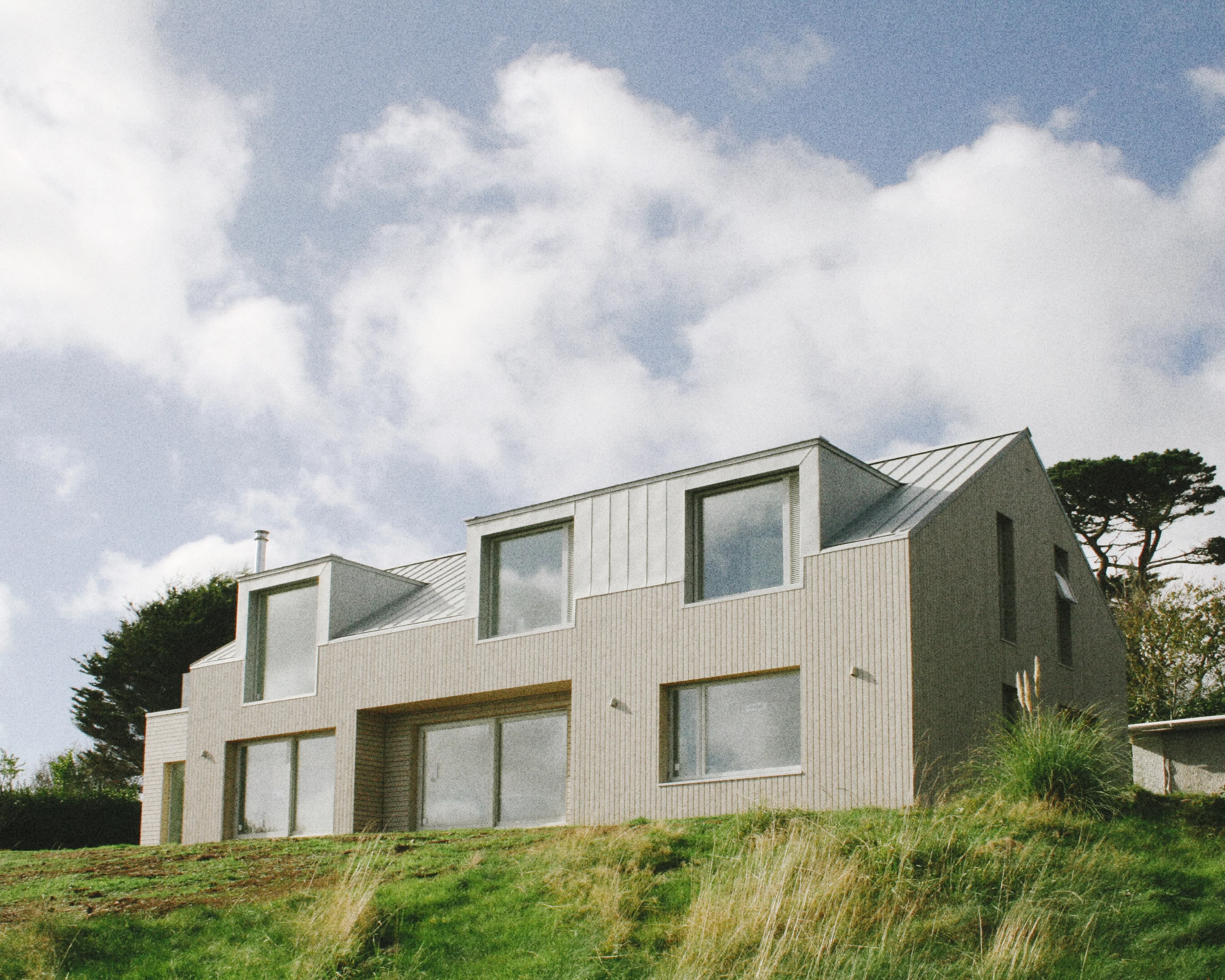 Aerial view of a house within its landscaped plot