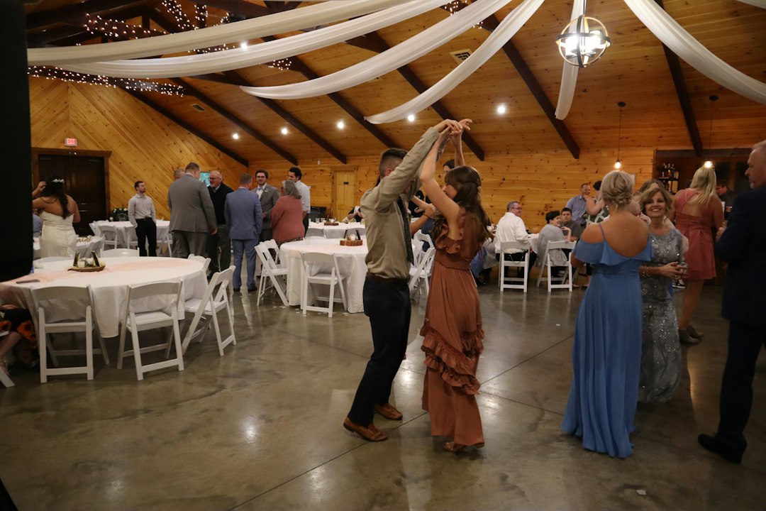 wedding guests watching parent dances on an illuminated dance floor
