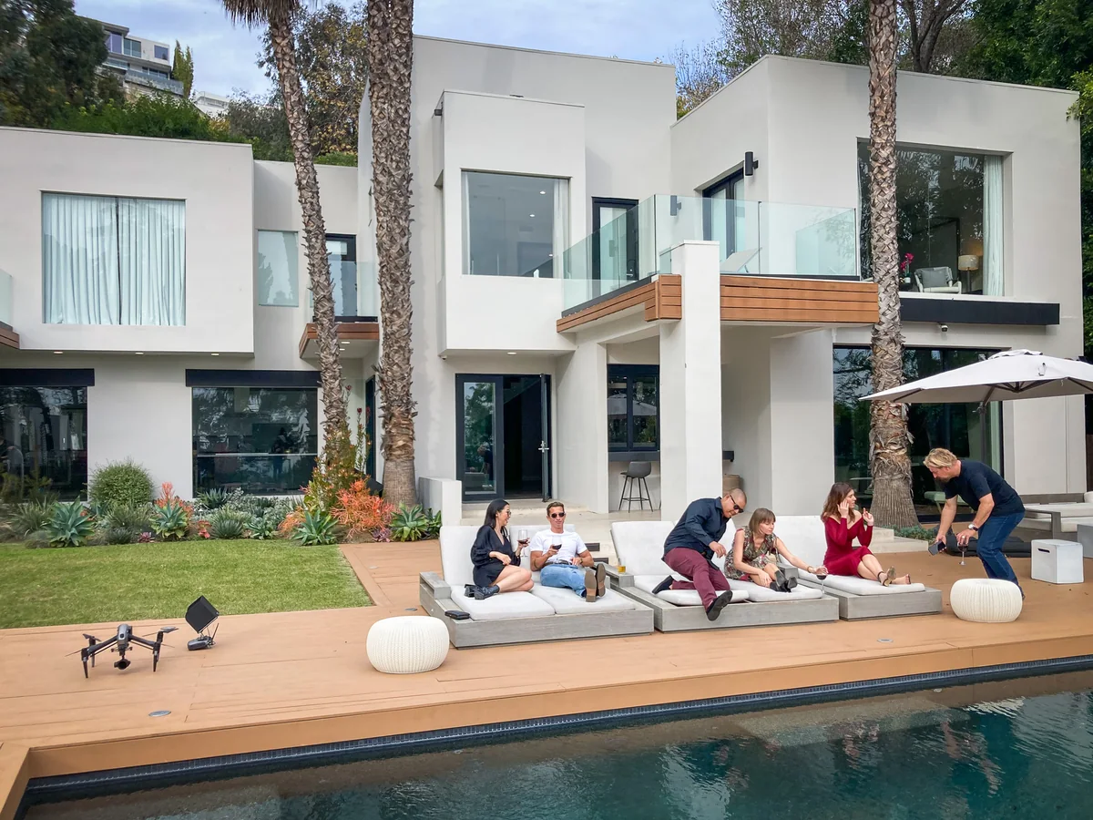 Production crew working on a poolside location shoot.