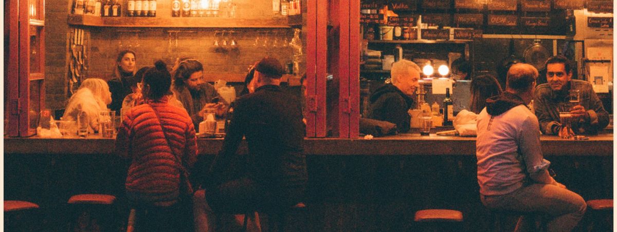 A busy London pub bar in the evening