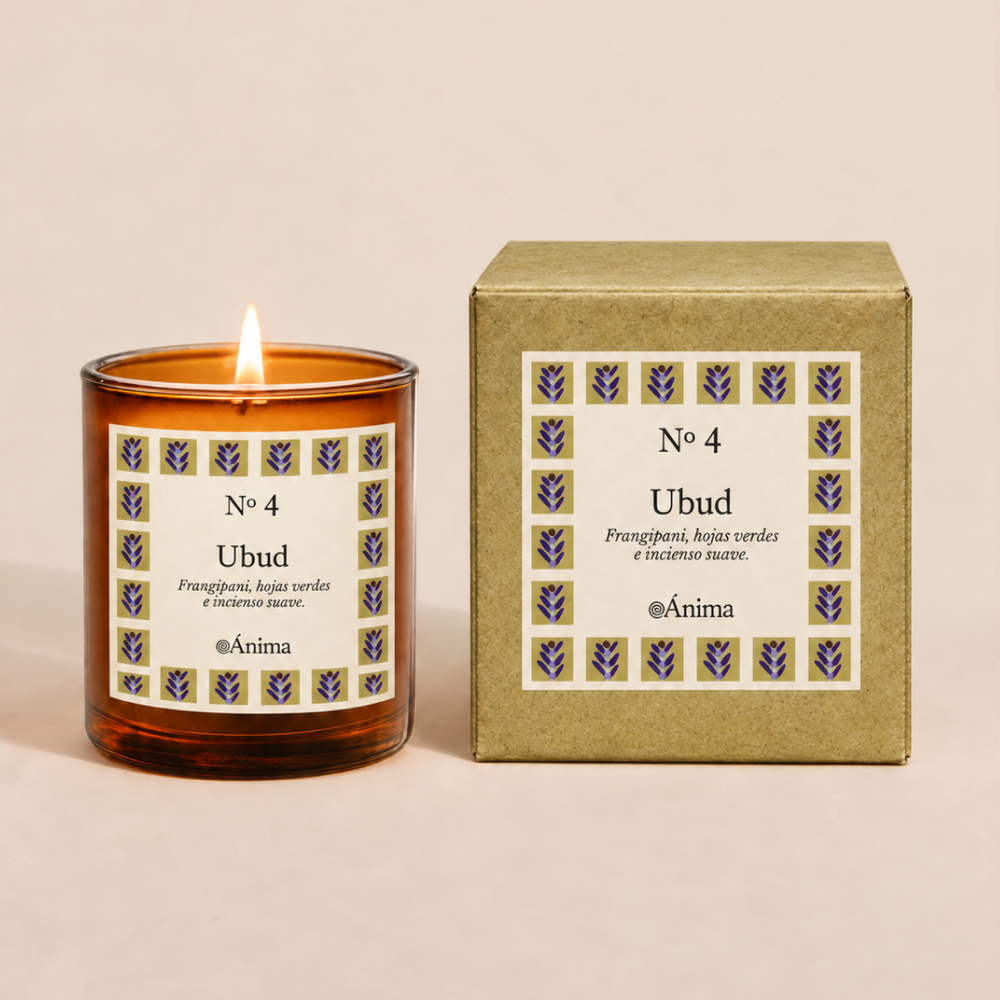 Lit amber glass candle labeled 'No 4 Ubud' with scent notes of frangipani, green leaves, and soft incense, next to matching box with the same label design featuring purple leaf motifs.