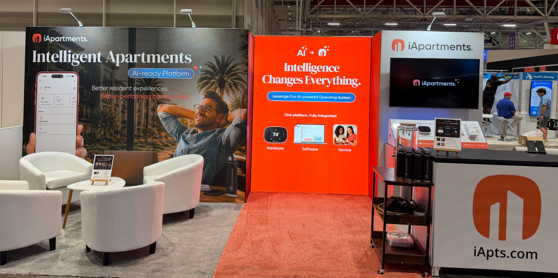 iApartments trade show booth with lounge seating and product displays