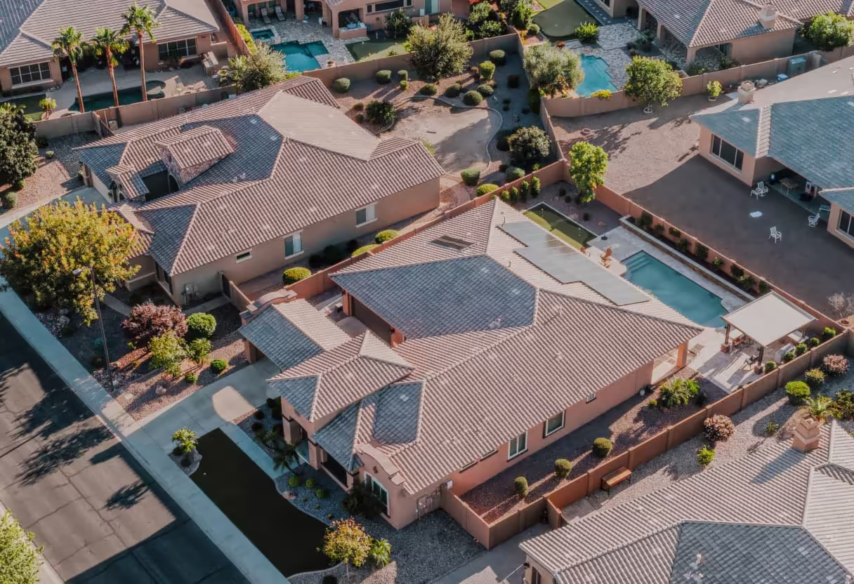 Aerial view of tile-roof homes with rooftop solar