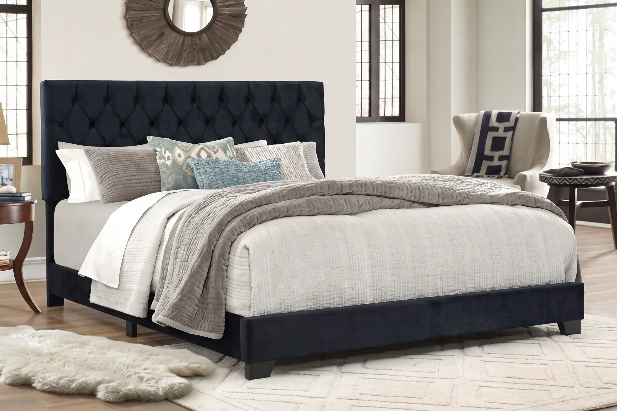 Black upholstered bed frame with a button-tufted headboard in a bright bedroom