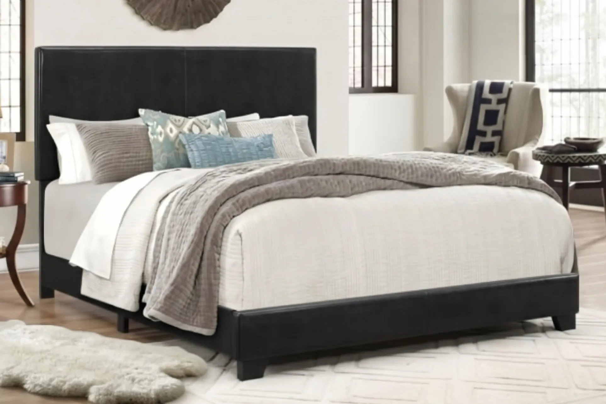 Erin black upholstered complete bed in a bright bedroom