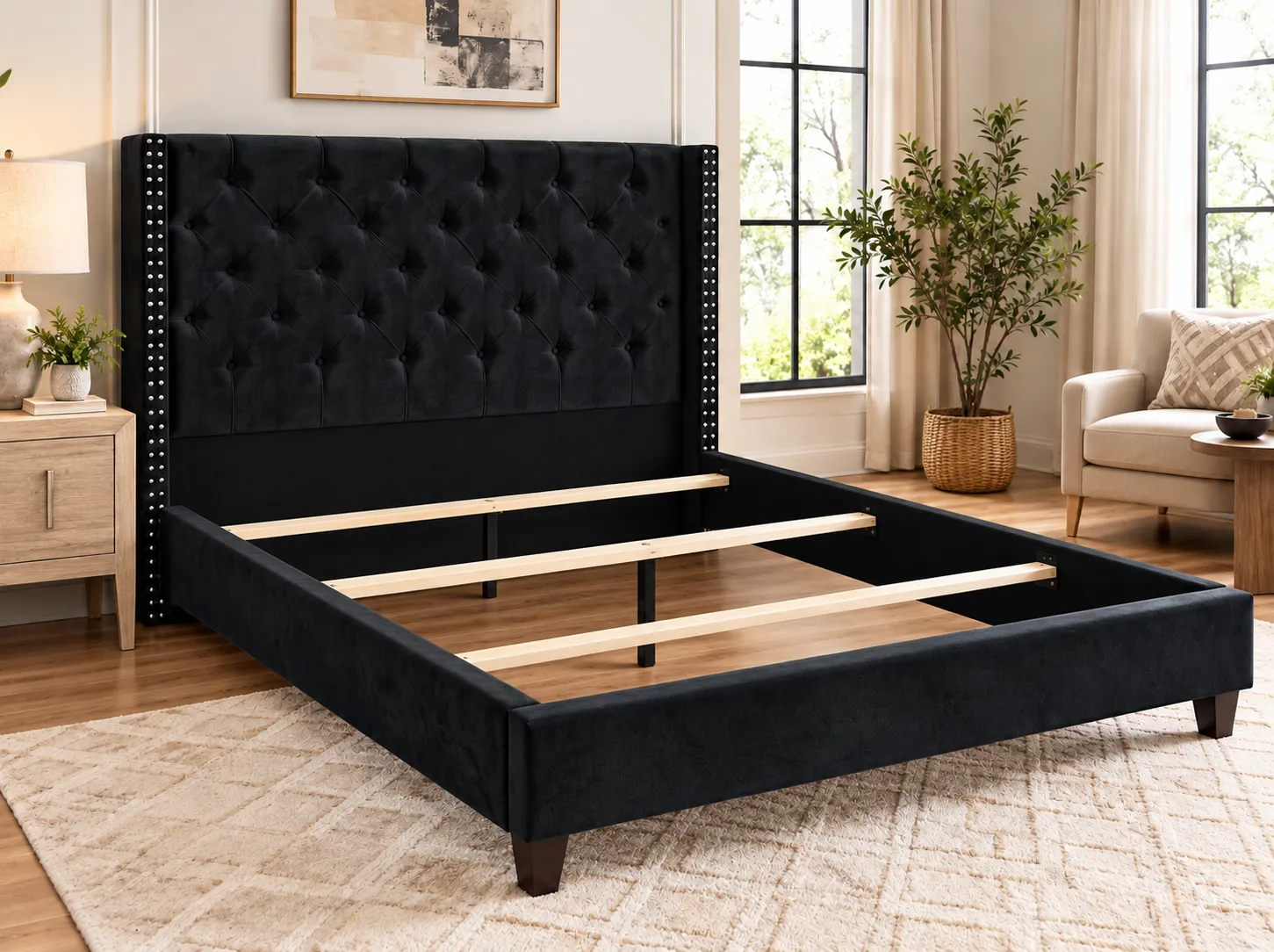 Black Wingback Tufted Bed frame without a mattress, showing the wood slats and center support legs