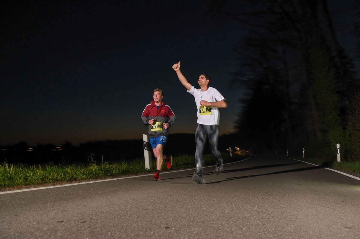 NightRun 2017 Wallisellen: Zwei Läufer in der Nacht, einer winkt