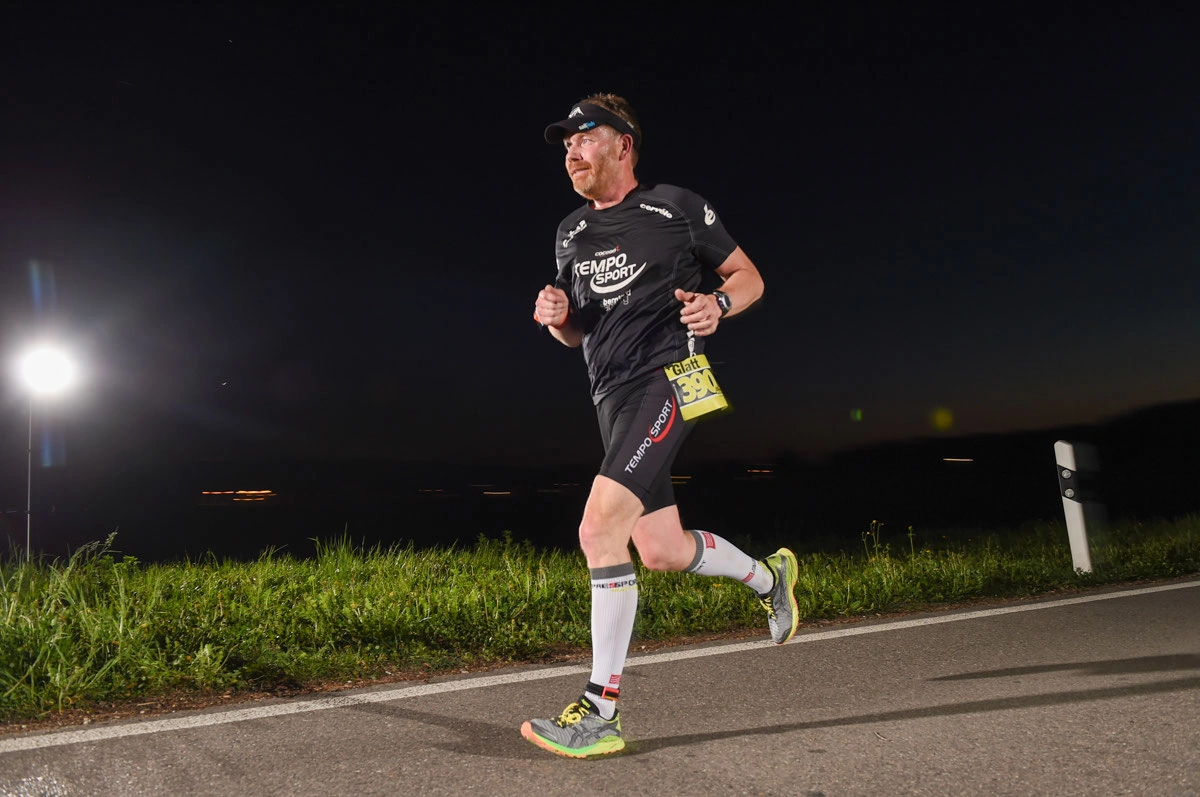 NightRun 2018 Wallisellen: Läufer im schwarzen Shirt auf der Strecke in der Dämmerung