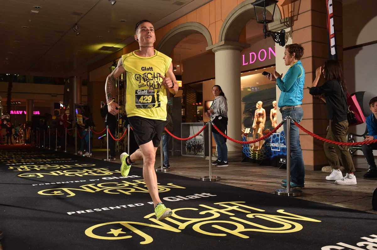 Glatt NightRun 2017: Läufer im gelben Shirt rennt am Absperrband vorbei