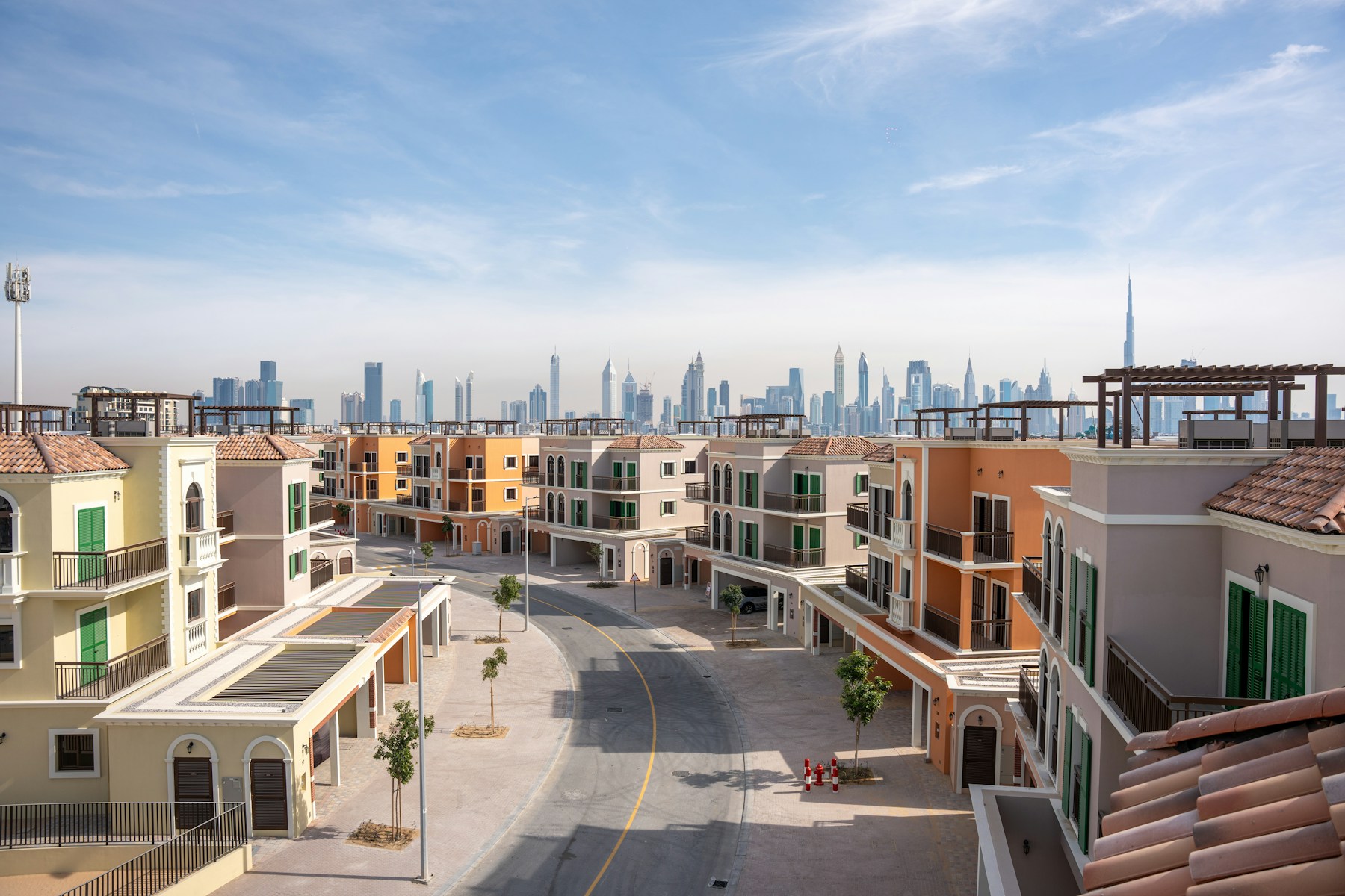 A residential neighbourhood in Dubai with contemporary townhouses and the skyline beyond