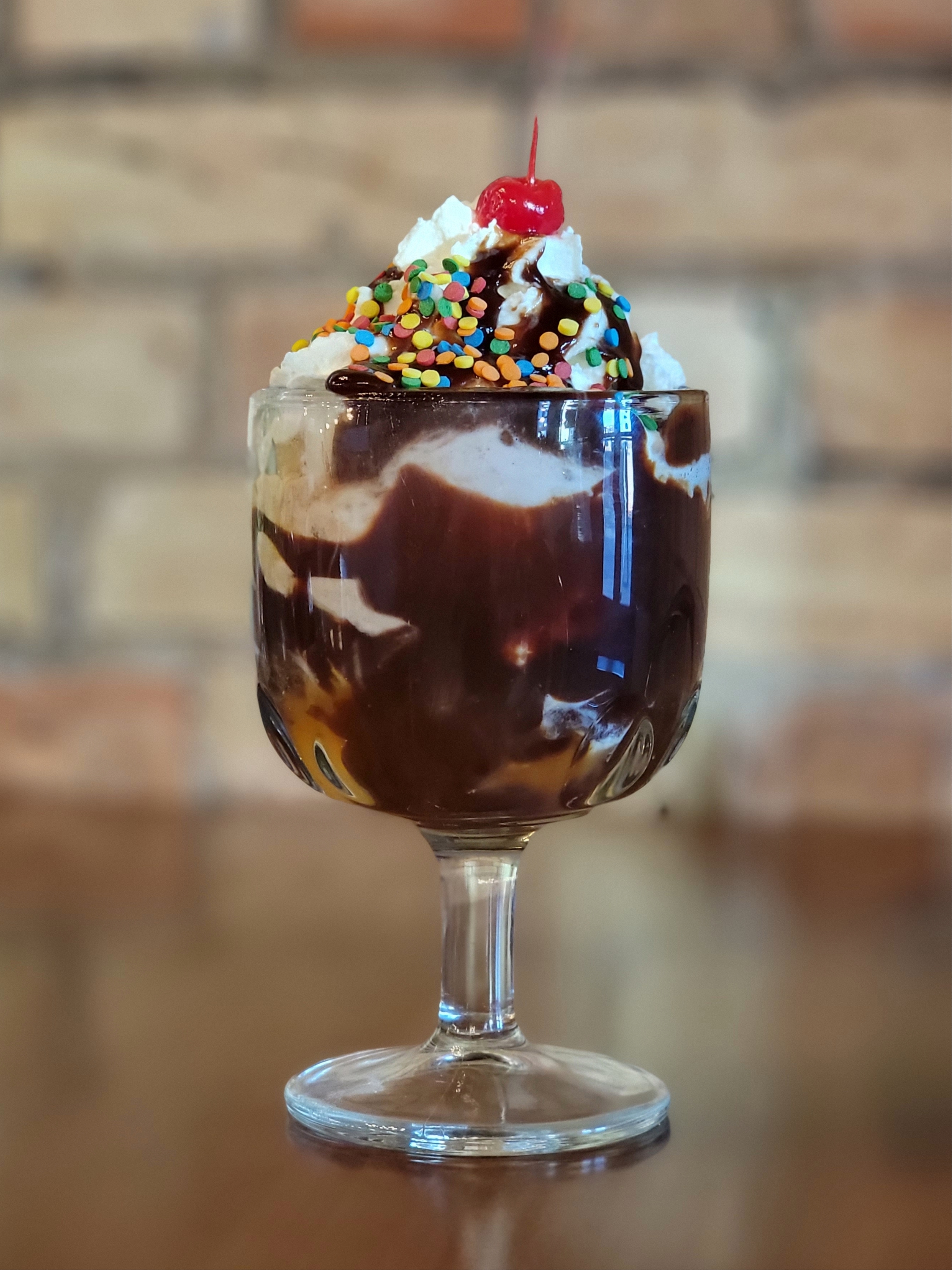 Hot fudge sundae topped with whipped cream